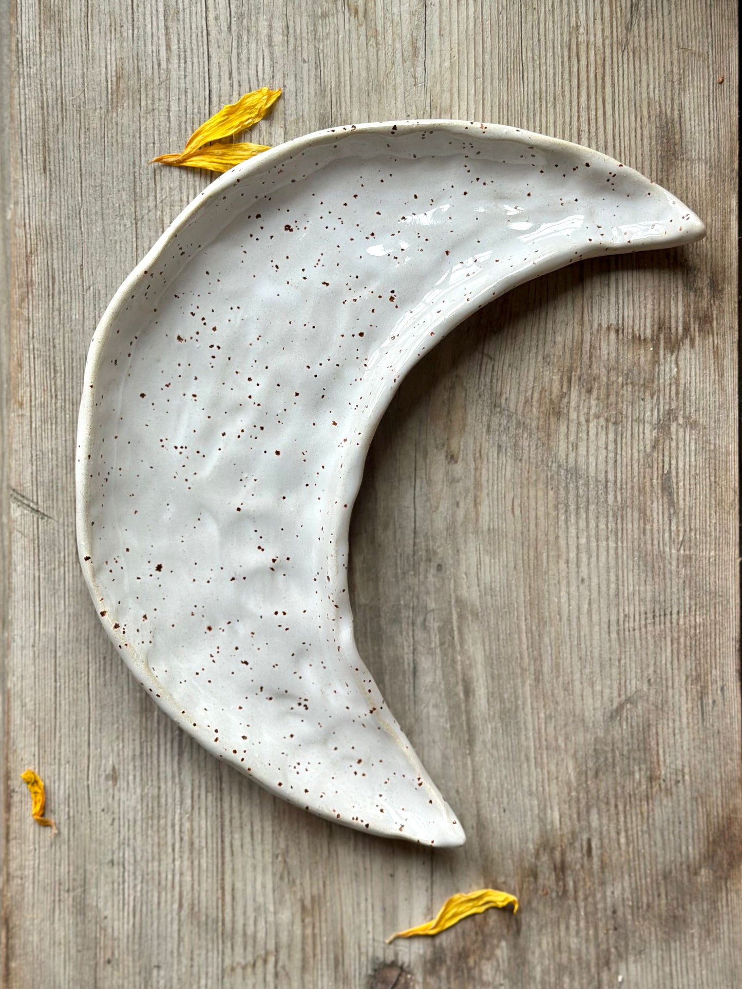 Moon shaped decorative ceramic tray with white glaze.