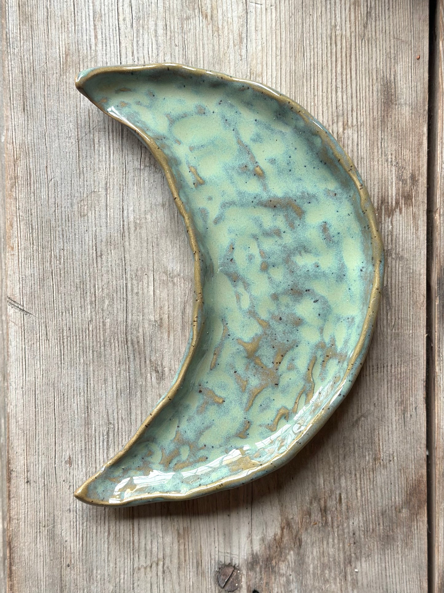 Moon shaped decorative tray with turqoise green glaze.