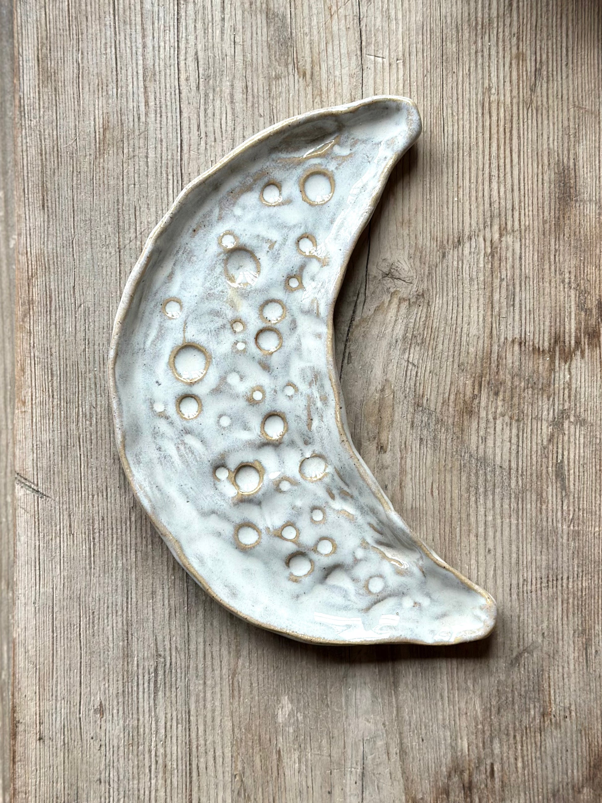 Moon shaped decorative tray in white glaze.