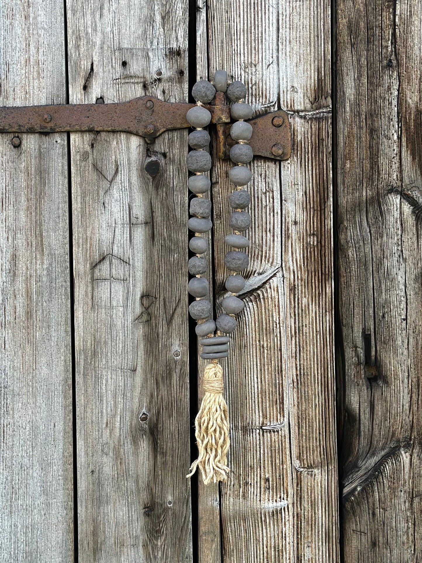 Studio Meraki Decorative ceramic bead garland with black beads and hemp tassle