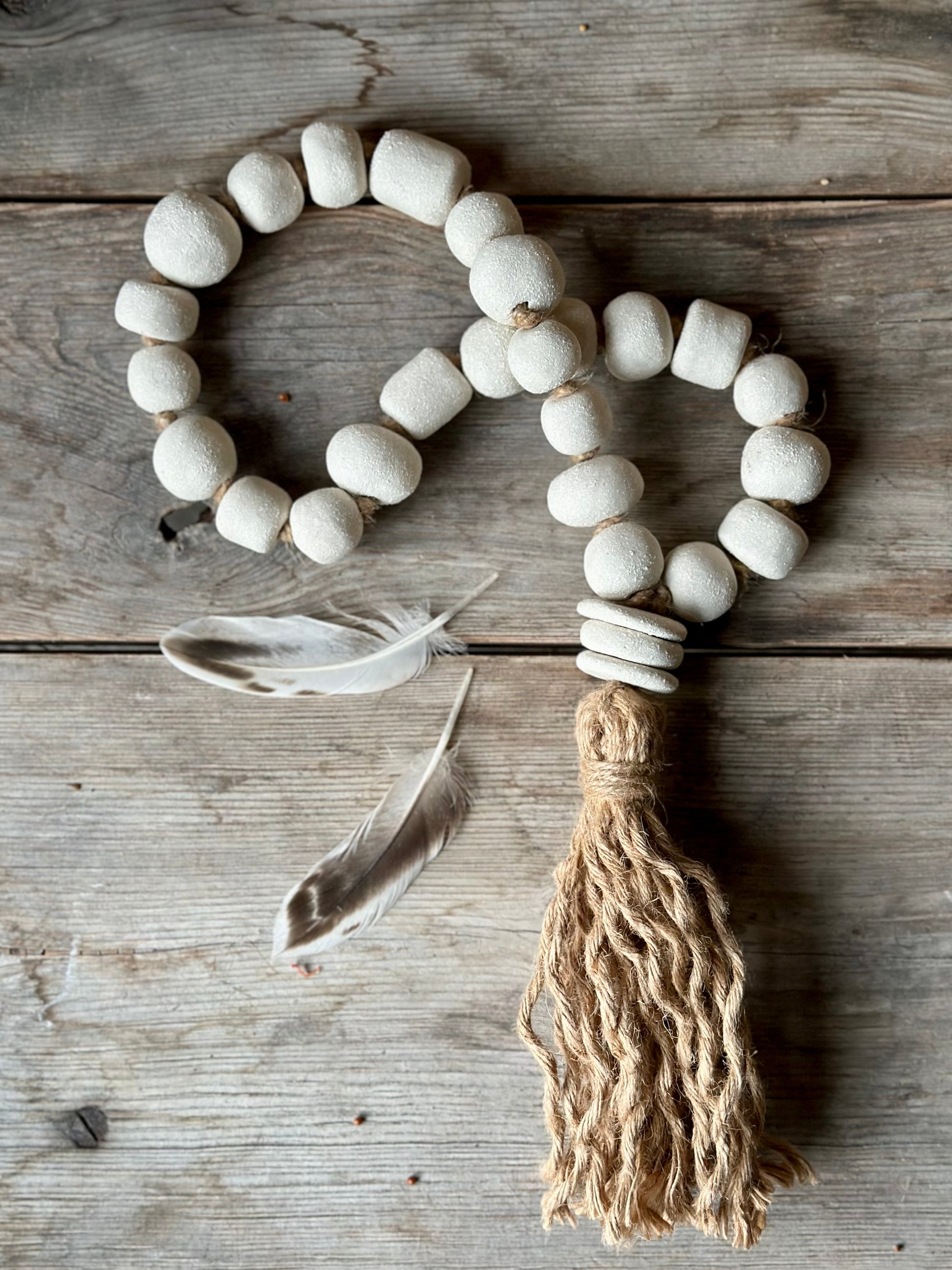 Studio Meraki Decorative ceramic bead garland with black beads and hemp tassle