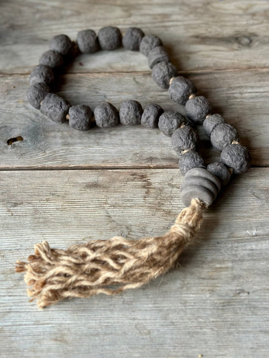 Studio Meraki Decorative ceramic bead garland with black beads and hemp tassle