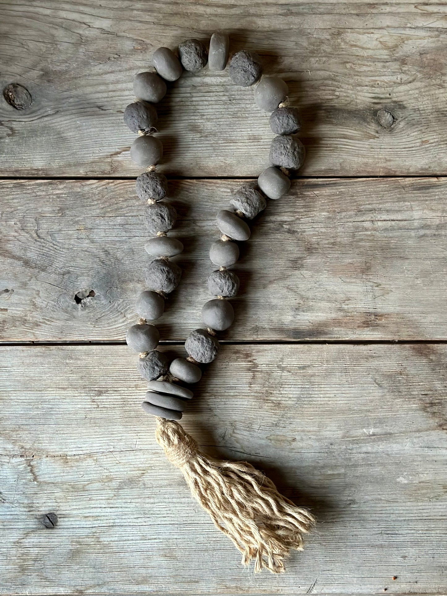 Studio Meraki Decorative ceramic bead garland with black beads and hemp tassle